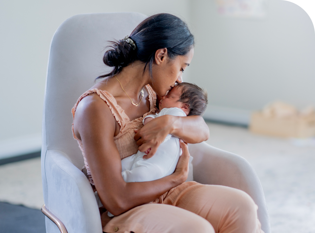 indian mother embraces newborn baby